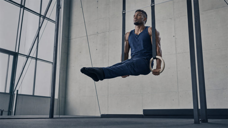 Gymnast holding a controlled strength position on still rings