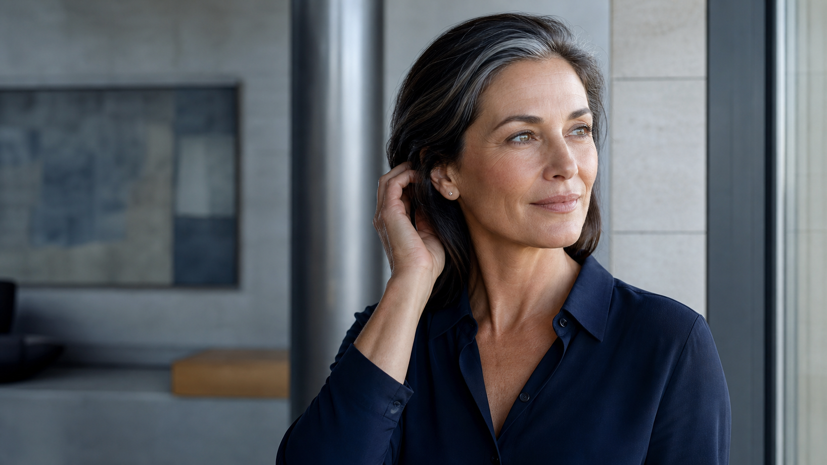 Confident mature woman with natural skin and a silver streak in her hair